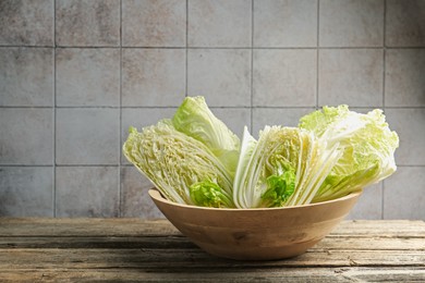 Photo of Fresh Chinese cabbages on wooden table, closeup. Space for text
