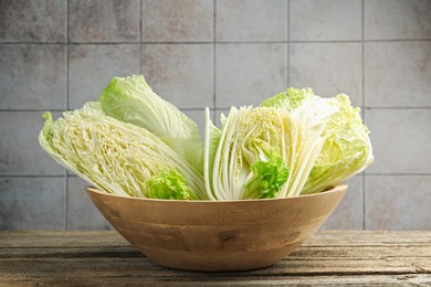 Photo of Fresh Chinese cabbages on wooden table, closeup