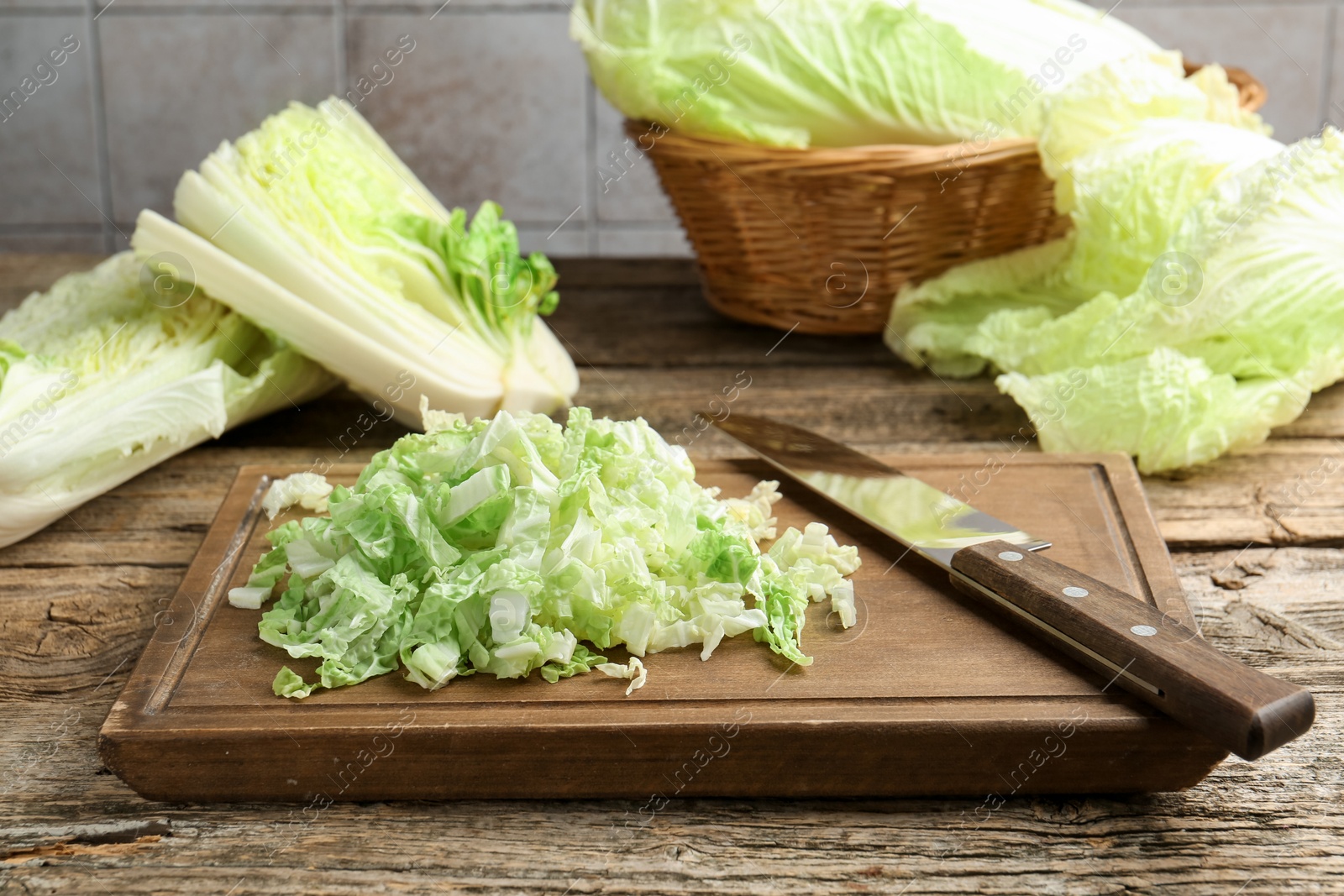 Cut Chinese cabbages and knife on wooden table, closeup Photo of Cut Chinese cabbages and knife on wooden table, closeup