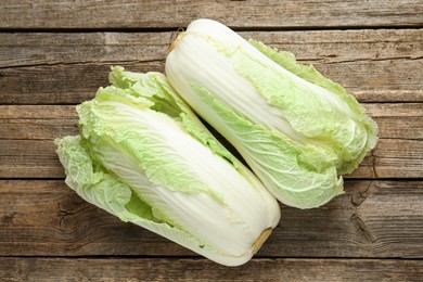 Photo of Fresh Chinese cabbages on wooden table, top view