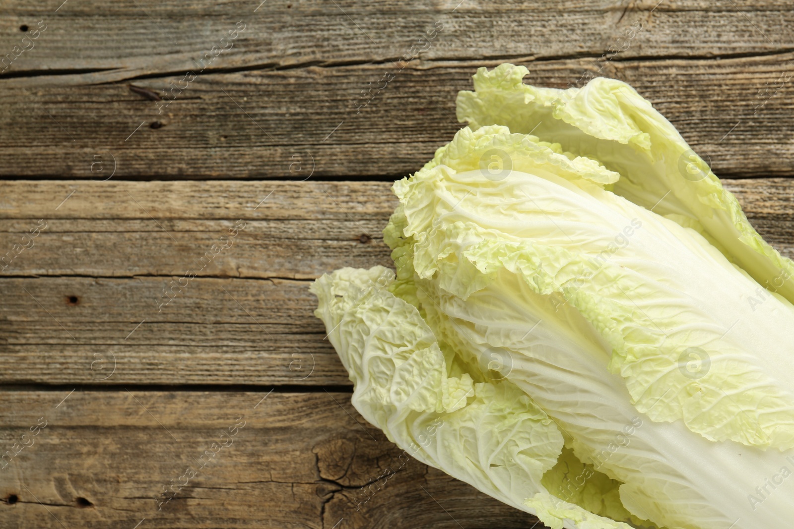 Fresh Chinese cabbage on wooden table, top view. Space for text Photo of Fresh Chinese cabbage on wooden table, top view. Space for text