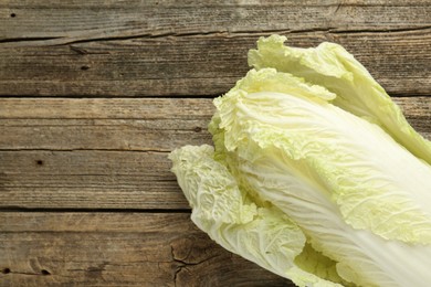 Photo of Fresh Chinese cabbage on wooden table, top view. Space for text