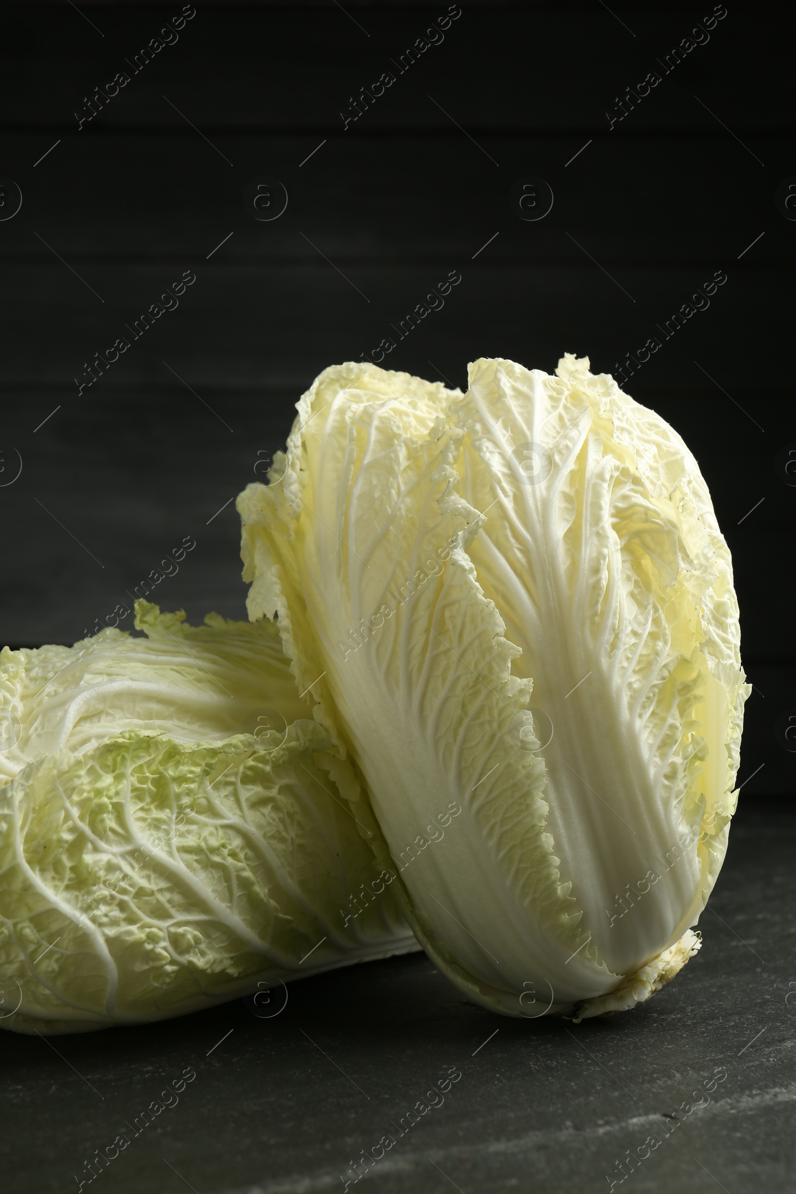 Fresh Chinese cabbages on black table, closeup Photo of Fresh Chinese cabbages on black table, closeup