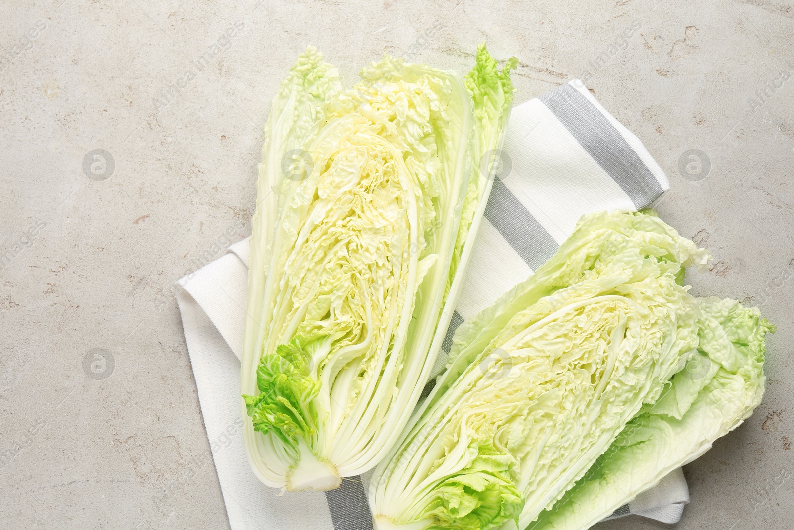 Cut Chinese cabbage on light grey table, top view Photo of Cut Chinese cabbage on light grey table, top view