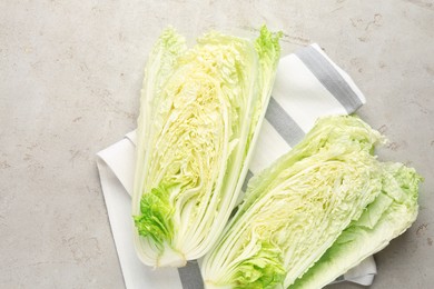 Photo of Cut Chinese cabbage on light grey table, top view