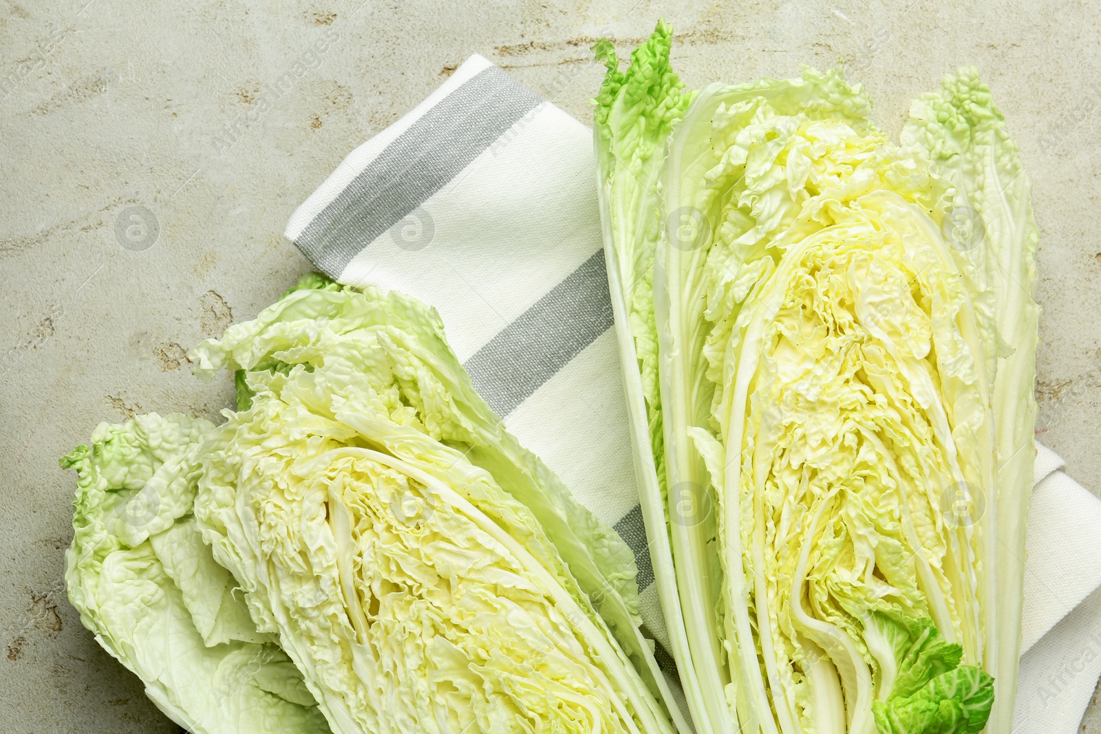 Cut Chinese cabbage on light grey table, top view Photo of Cut Chinese cabbage on light grey table, top view