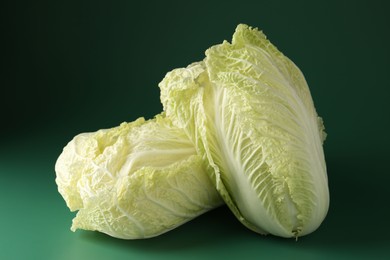 Photo of Fresh Chinese cabbages on green background, closeup