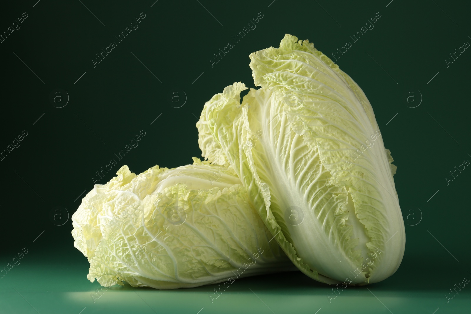 Fresh Chinese cabbages on green background, closeup Photo of Fresh Chinese cabbages on green background, closeup