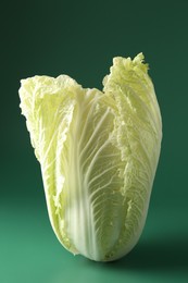 Photo of Fresh Chinese cabbage on green background, closeup