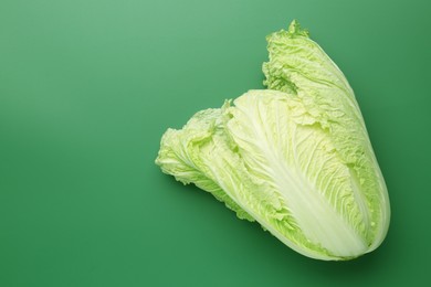 Photo of Fresh Chinese cabbage on green background, top view. Space for text