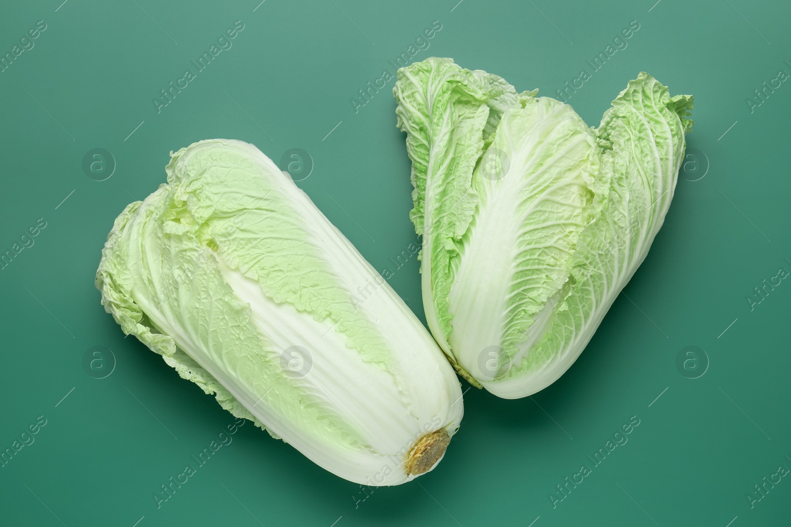 Fresh Chinese cabbages on green background, top view Photo of Fresh Chinese cabbages on green background, top view