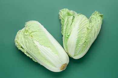 Photo of Fresh Chinese cabbages on green background, top view