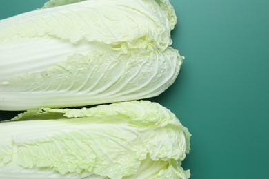 Photo of Fresh Chinese cabbages on green background, top view
