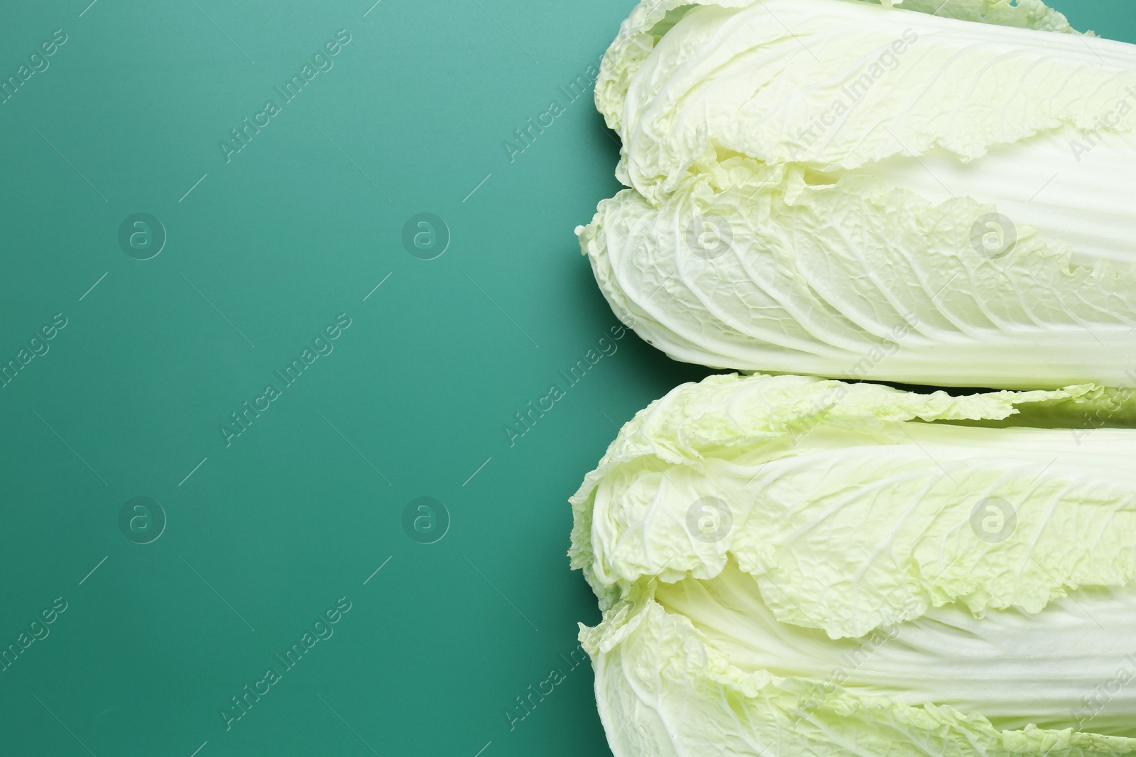 Fresh Chinese cabbages on green background, top view. Space for text Photo of Fresh Chinese cabbages on green background, top view. Space for text