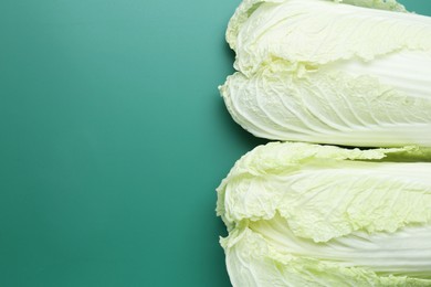 Photo of Fresh Chinese cabbages on green background, top view. Space for text