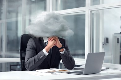Image of Businessman with cloud instead of head at table in office. Mental health