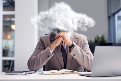 Image of Businessman with cloud instead of head at table in office. Mental health