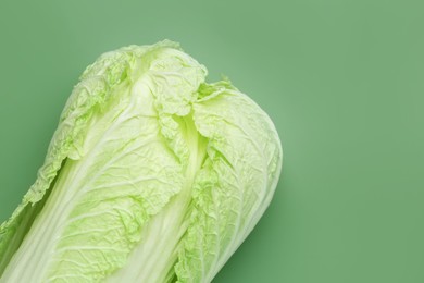 Photo of Fresh Chinese cabbage on green background, top view. Space for text