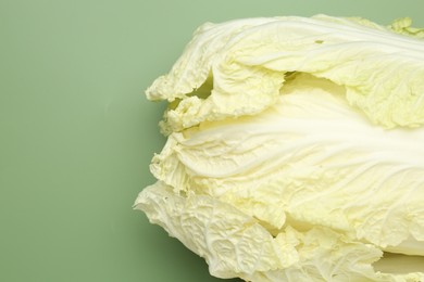 Photo of Fresh Chinese cabbage on green background, top view. Space for text