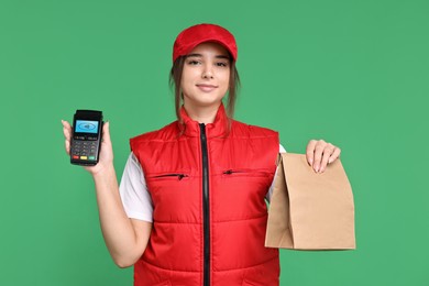 Image of Worker holding payment terminal and paper bag on green background
