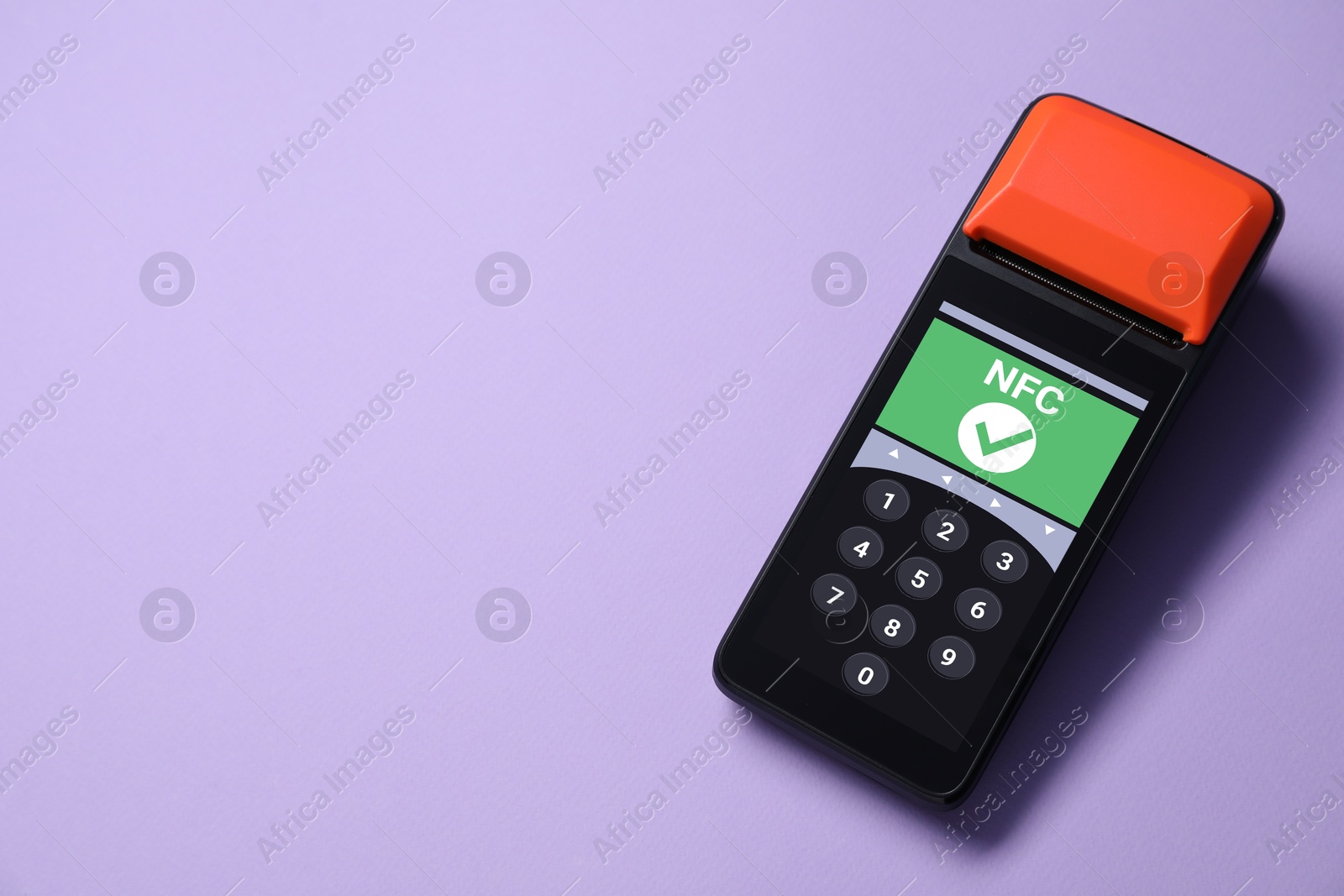 Payment terminal with NFC system on pale purple background, top view. Space for text Image of Payment terminal with NFC system on pale purple background, top view. Space for text