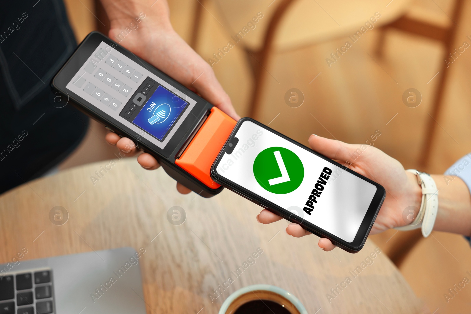Payment terminal with NFC system. Client using mobile phone to pay for service in cafe, closeup Image of Payment terminal with NFC system. Client using mobile phone to pay for service in cafe, closeup