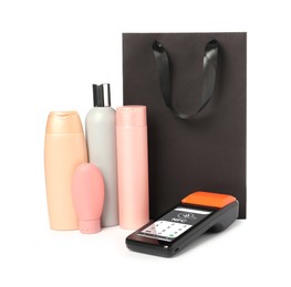 Image of Payment terminal with NFC system, personal care products and paper shopping bag on white background