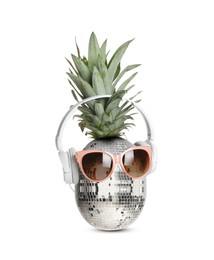 Image of Disco ball pineapple with sunglasses and headphones on white background, creative collage