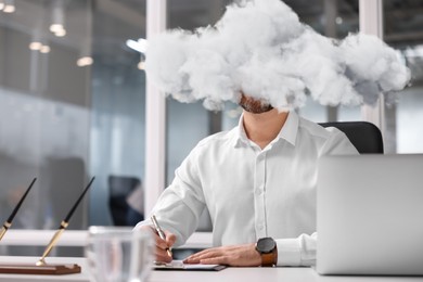 Image of Businessman with cloud instead of head at table in office. Mental health