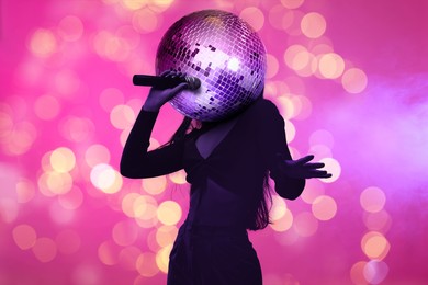 Image of Woman with disco ball head singing on stage, creative collage