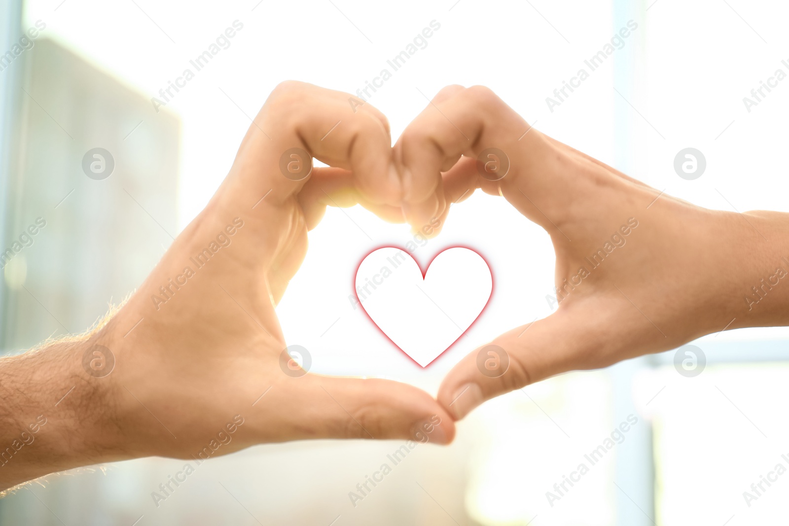 Man and woman making heart with their hands indoors, closeup Image of Man and woman making heart with their hands indoors, closeup