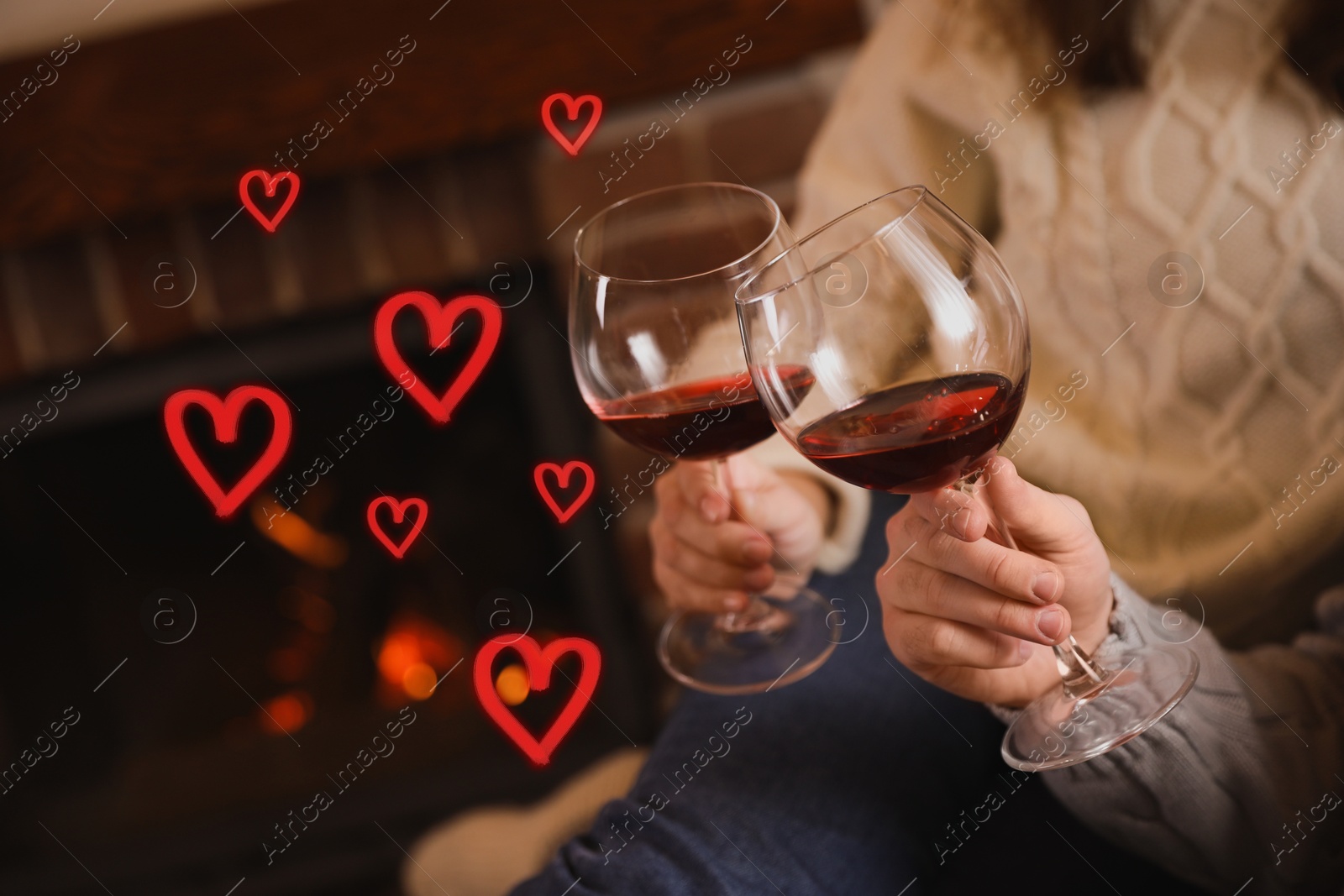 Couple with glasses of red wine indoors, closeup. Drawn hearts near them Image of Couple with glasses of red wine indoors, closeup. Drawn hearts near them