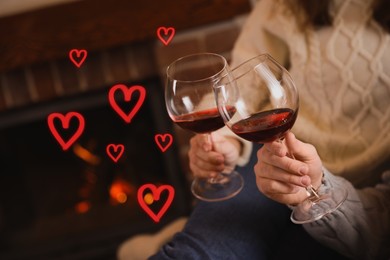 Image of Couple with glasses of red wine indoors, closeup. Drawn hearts near them