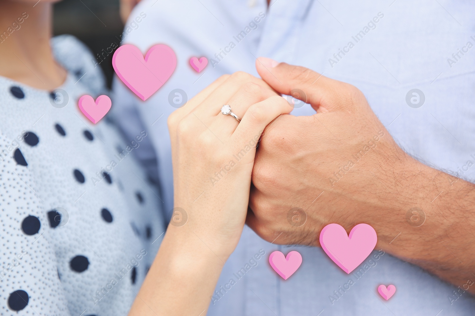 Lovely engaged couple holding hands, closeup. Drawn hearts near them Image of Lovely engaged couple holding hands, closeup. Drawn hearts near them