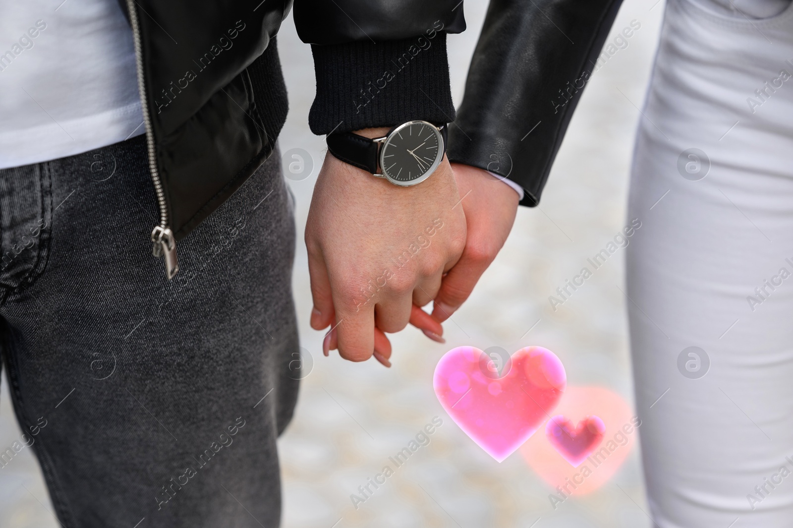 Lovely couple holding hands outdoors, closeup. Drawn hearts near them Image of Lovely couple holding hands outdoors, closeup. Drawn hearts near them
