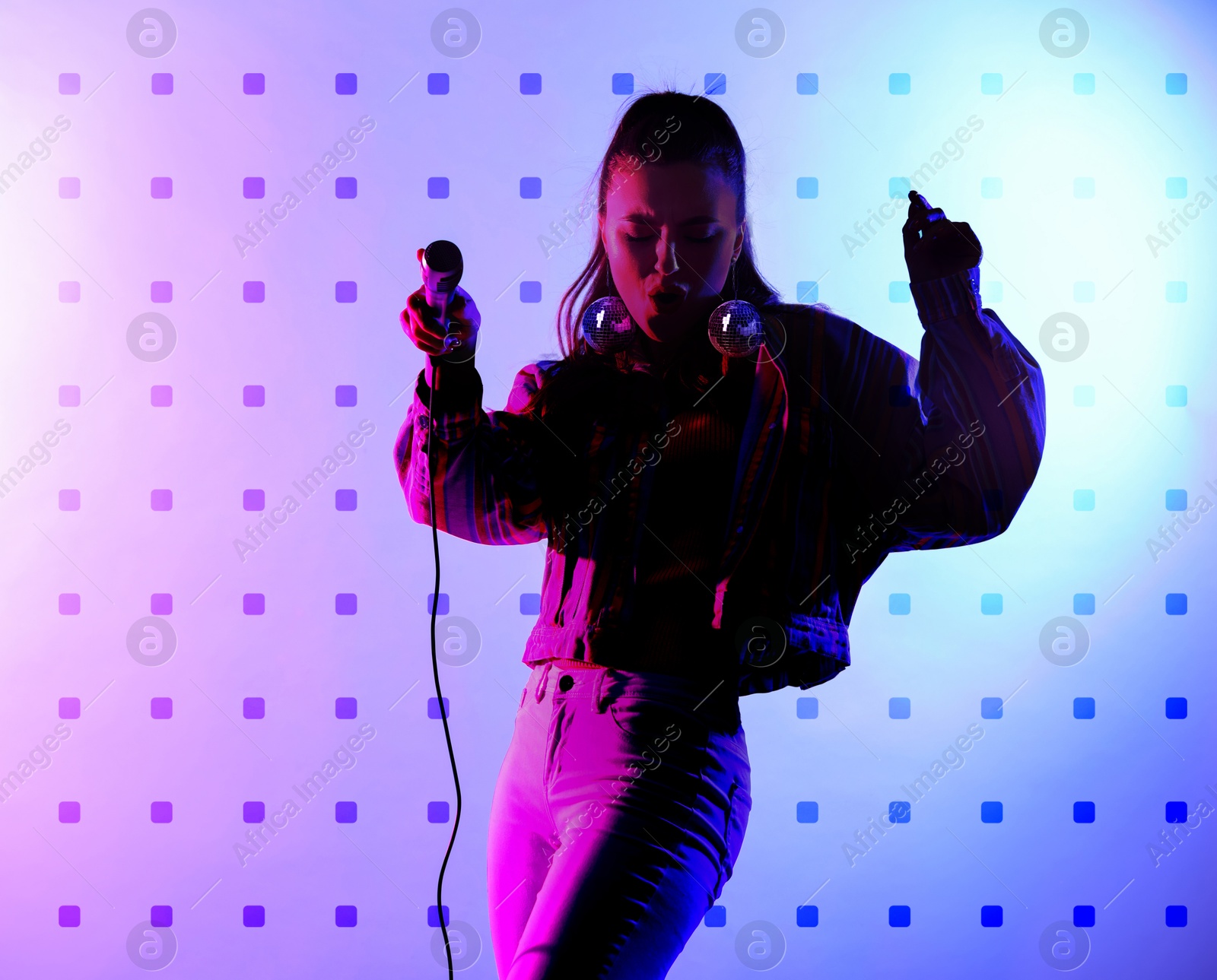 Beautiful woman with disco ball earrings singing on stage Image of Beautiful woman with disco ball earrings singing on stage