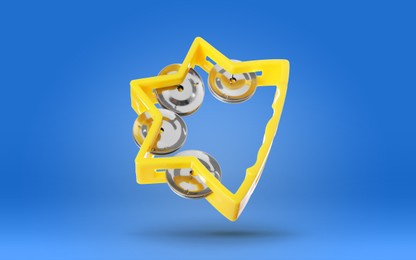 Image of Yellow toy tambourine in air on blue background. Child's musical instrument