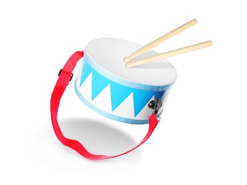 Image of Toy drum and sticks in air on white background. Child's musical instrument