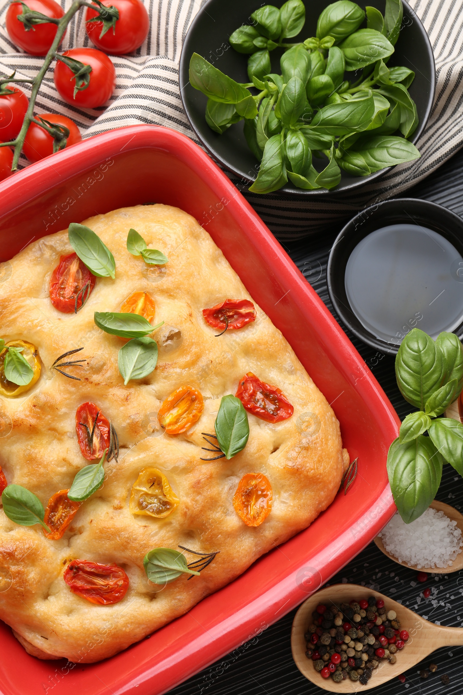 Delicious focaccia with tomatoes, spices and oil on table, flat lay Photo of Delicious focaccia with tomatoes, spices and oil on table, flat lay