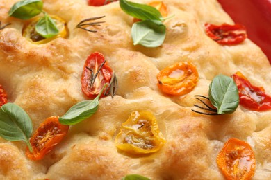 Photo of Delicious focaccia with tomatoes and spices as background, closeup