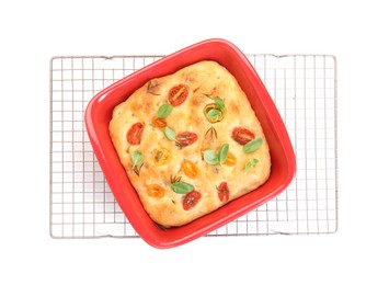 Photo of Delicious focaccia with tomatoes and spices in baking dish isolated on white, top view