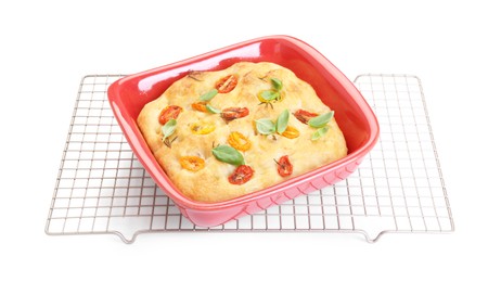 Photo of Delicious focaccia with tomatoes and spices in baking dish isolated on white