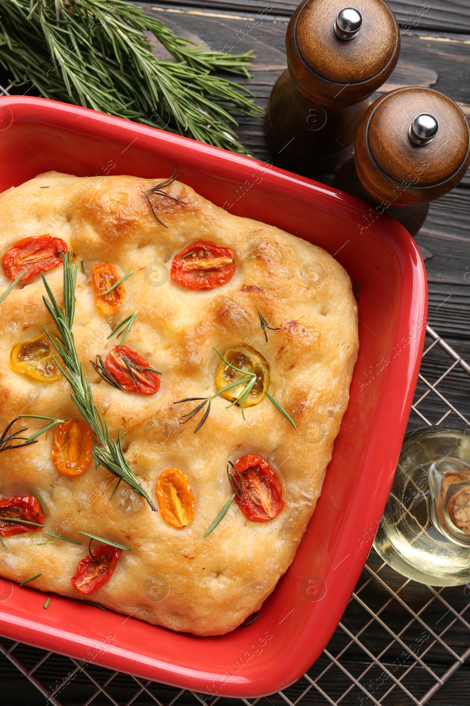 Delicious focaccia with tomatoes, spices and oil on table, flat lay Photo of Delicious focaccia with tomatoes, spices and oil on table, flat lay