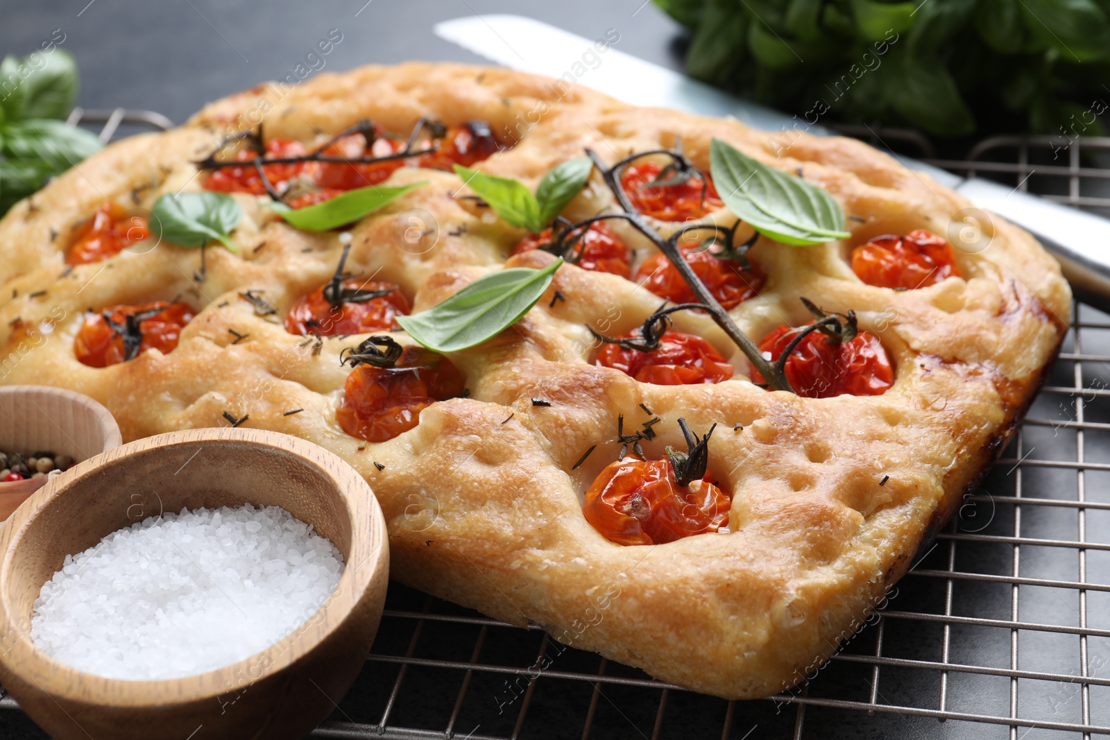 Delicious focaccia with tomatoes and spices on table, closeup Photo of Delicious focaccia with tomatoes and spices on table, closeup