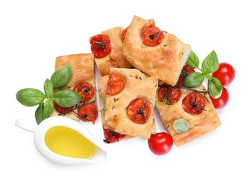 Photo of Pieces of delicious focaccia with tomatoes, spices and oil isolated on white, top view