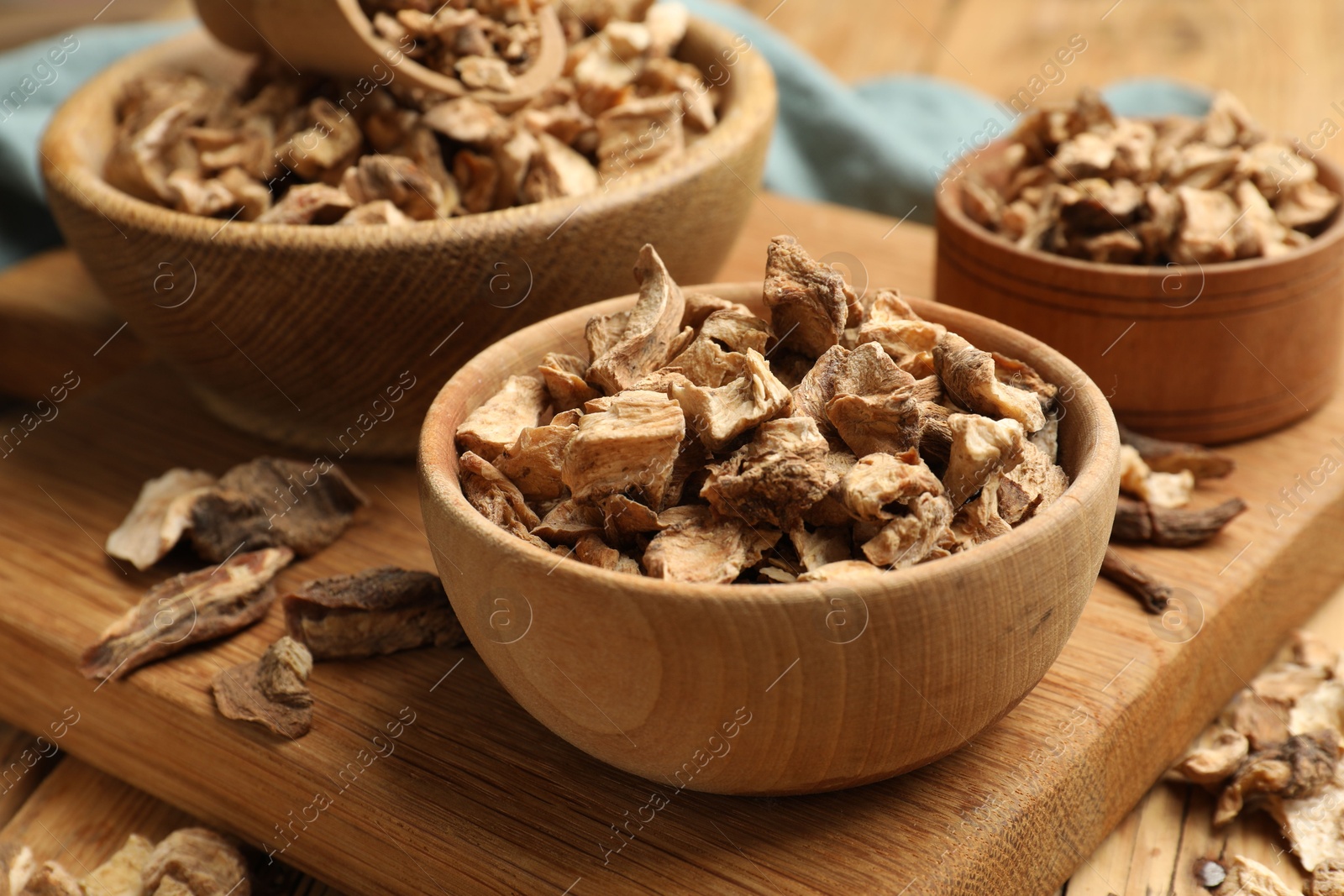 Pieces of dry chicory roots in bowls on table, closeup Photo of Pieces of dry chicory roots in bowls on table, closeup