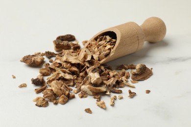 Photo of Pieces of dry chicory roots and scoop on white table
