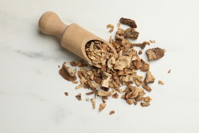 Photo of Pieces of dry chicory roots and scoop on white table, flat lay