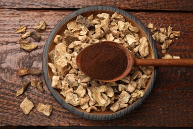 Photo of Pieces of dry chicory roots in bowl and spoon with powder on wooden table, top view