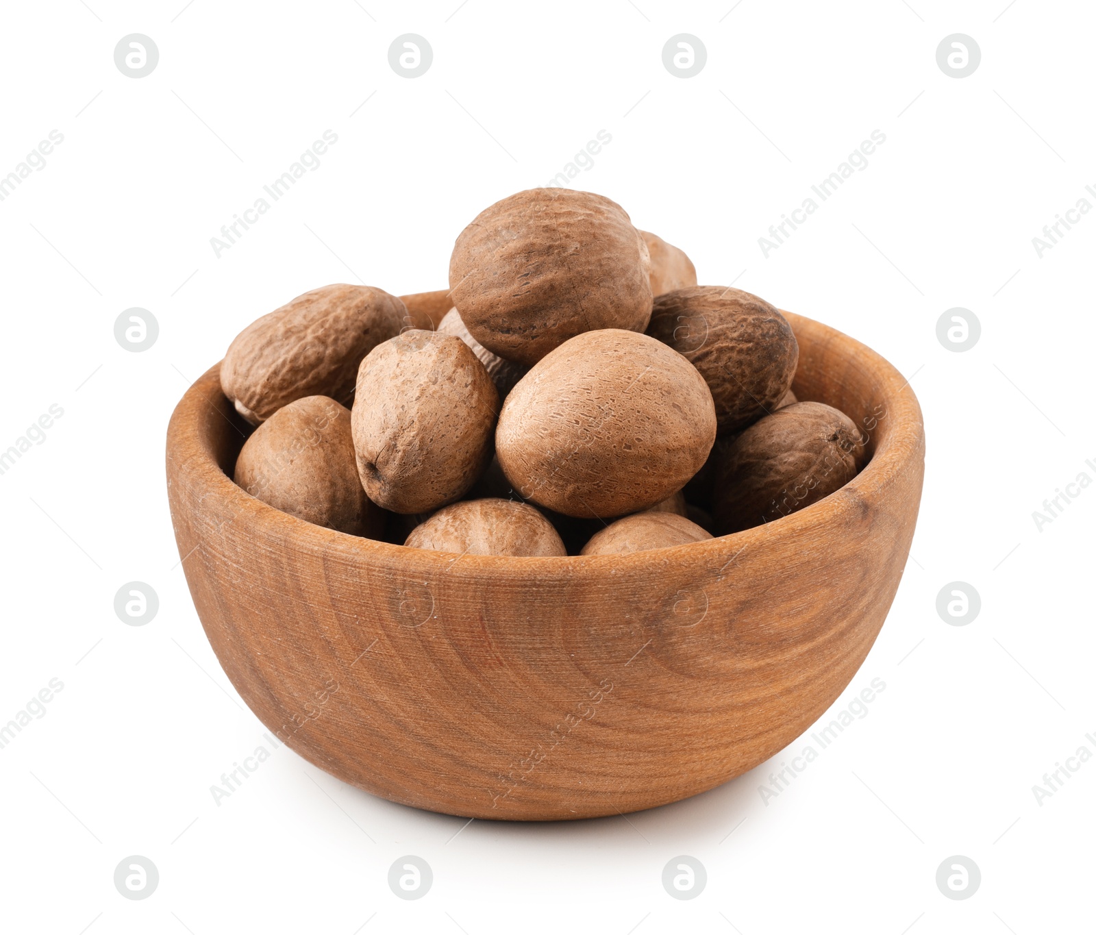 Fresh nutmegs in bowl isolated on white Photo of Fresh nutmegs in bowl isolated on white